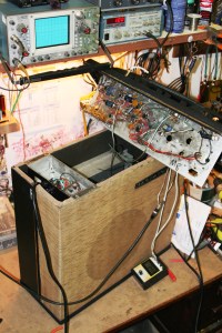 Flash ruined my pic but maybe I can't even say that because no flash was even worse. Oh well.  The top pops off and all the electronics are on one side of the chassis while all the tubes are on the other. All components are mounted to tag strips or to the tube sockets or pots. Power supply is propped up on the left of the chassis but it actually sits at the bottom of the enclosure screwed down into the cabinet. Amp had a torn speaker, AC cord inlet was broken, and had a wrong tube in the 12DW7 position. It's an untouched old relic but it still works. 